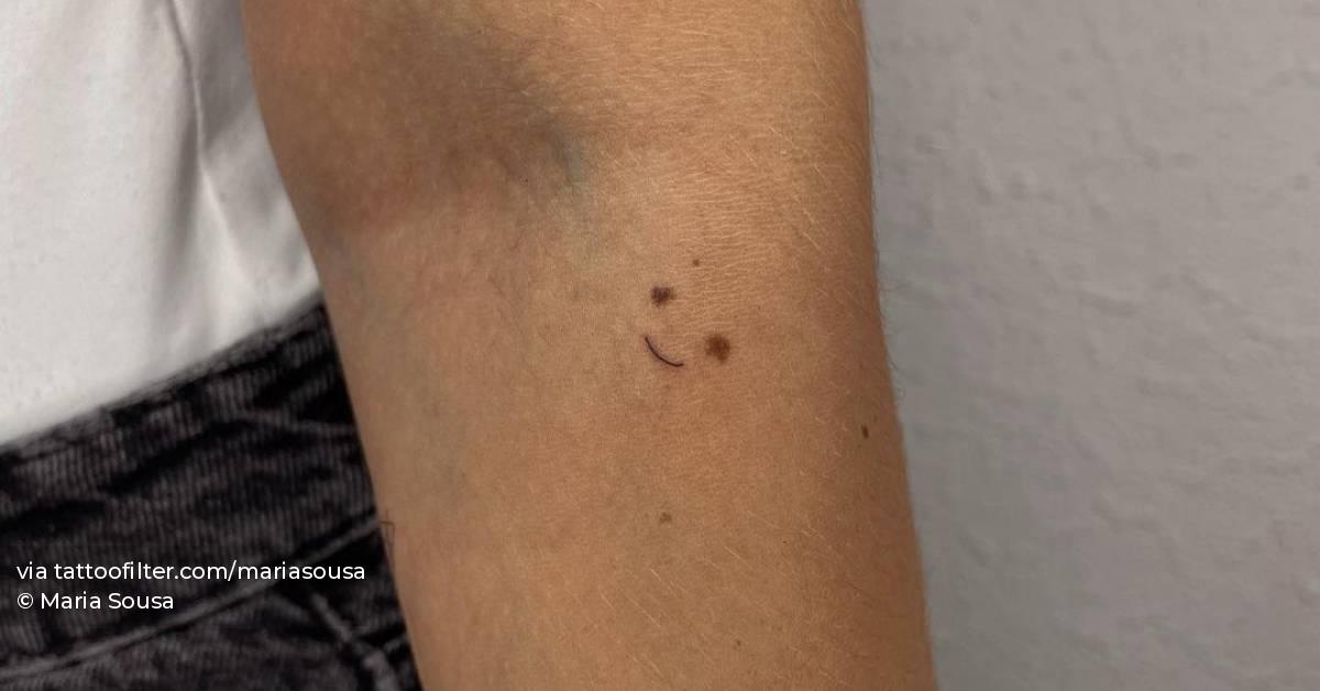 Minimalist birthmark coverup smiley tattoo on the