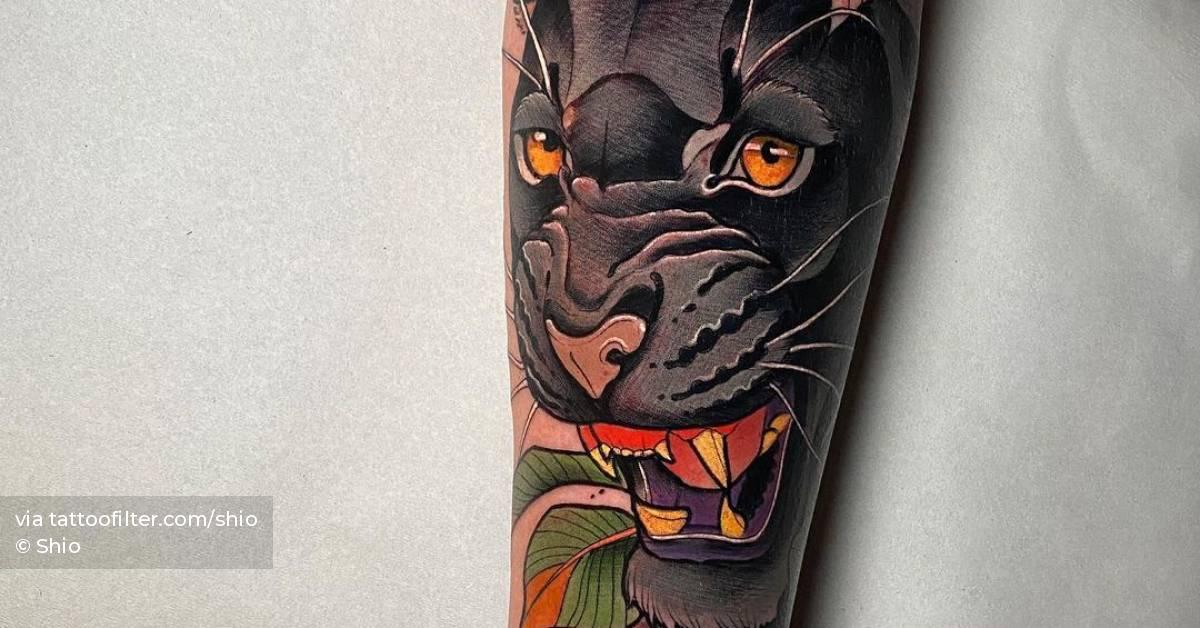 Neotraditional black panther tattoo on the forearm.