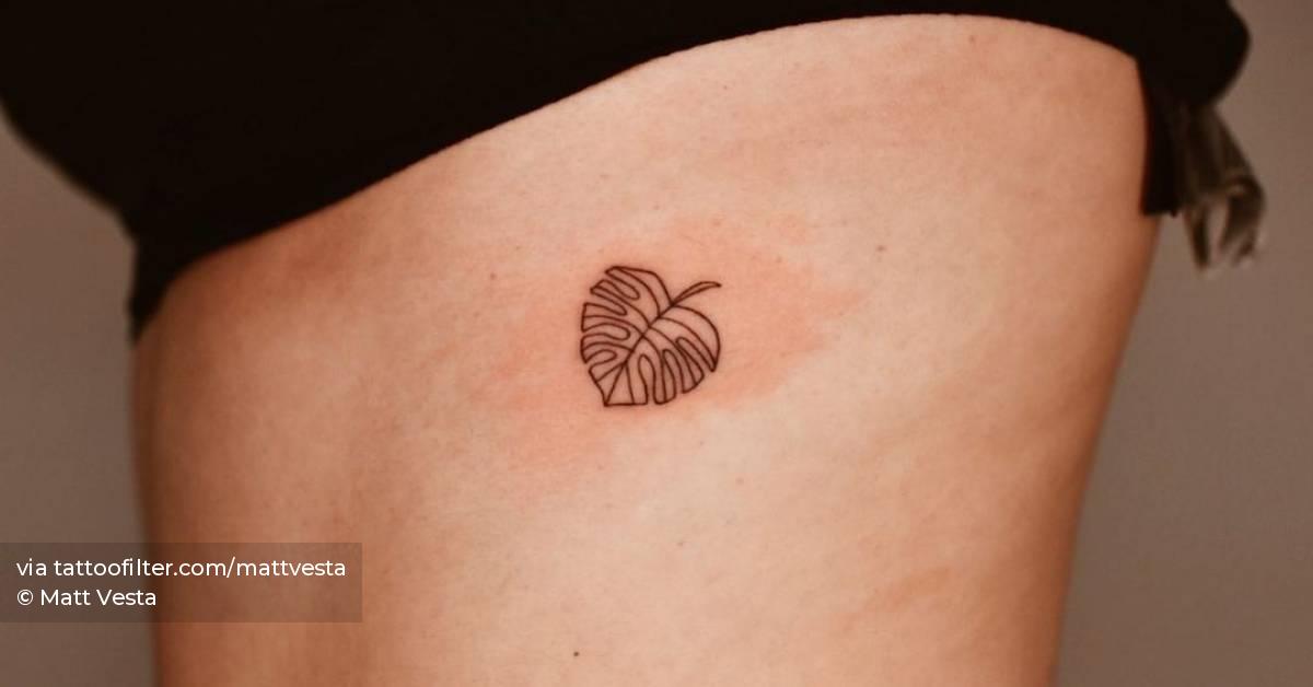 Fine line monstera leaf tattoo on the rib.