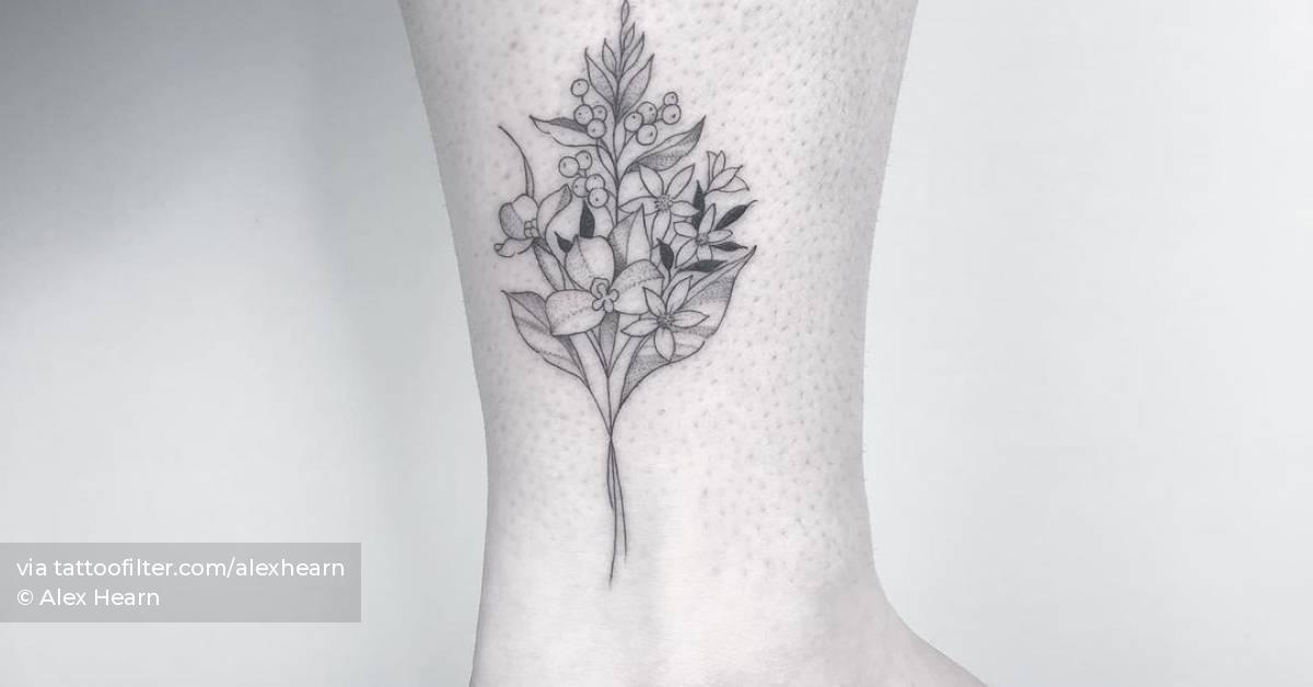 Fine line flower bouquet tattoo on the ankle.