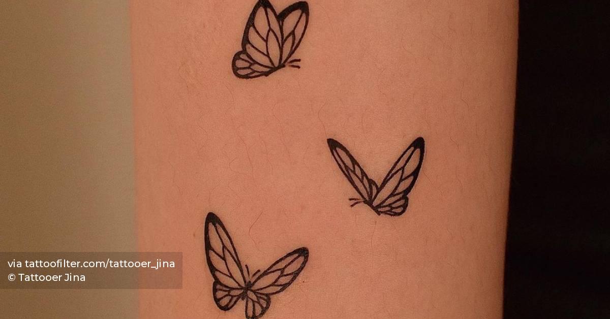 Minimalist butterflies tattoo on the tricep.