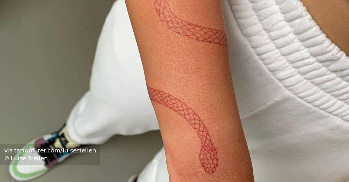 Fine line snake bracelet tattoo in red ink.