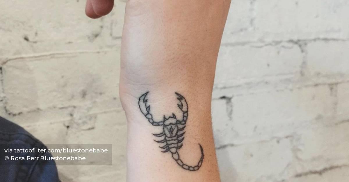 Hand poked scorpion tattoo on the wrist.