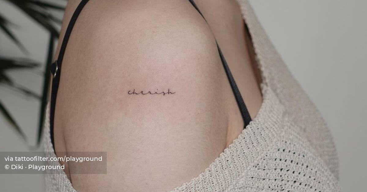 "Cherish" lettering tattoo on the shoulder.