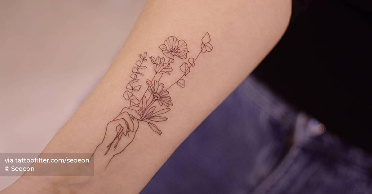 Hand Holding Flower Tattoo