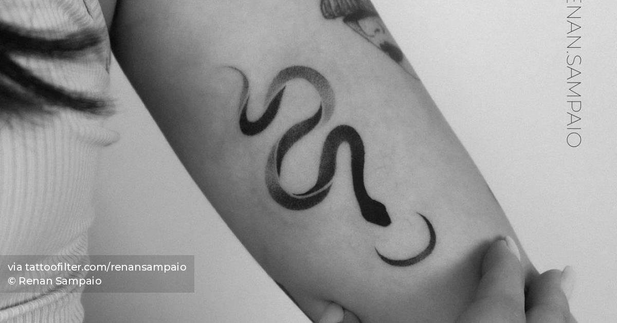 Snake tattoo on the inner arm.