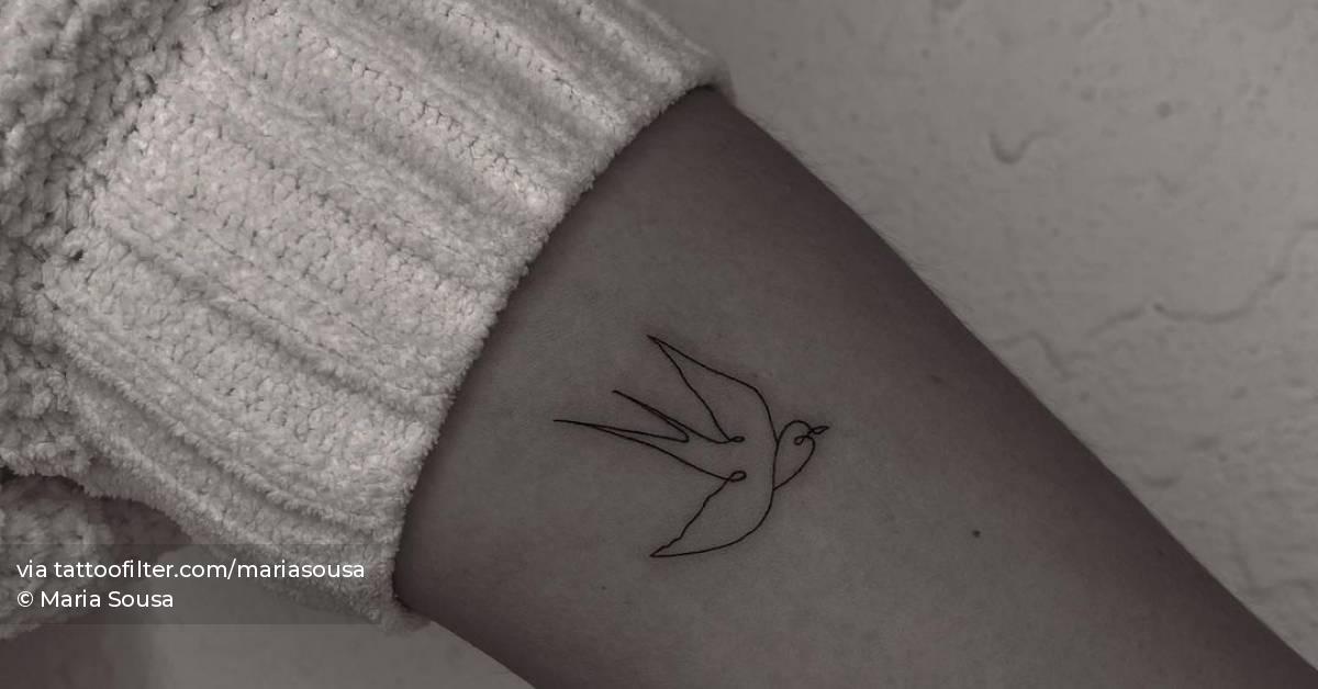 Minimalist swallow tattoo on the inner forearm.