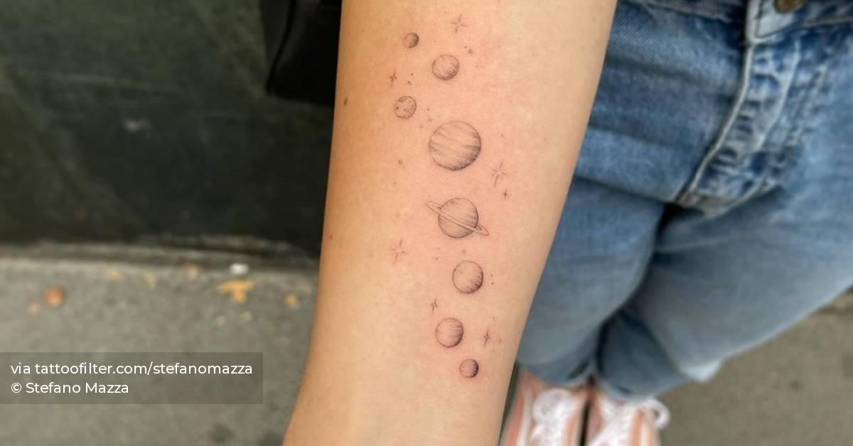 Solar system tattoo on the inner forearm.