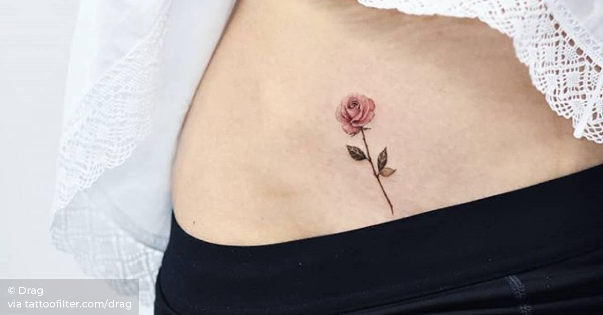 Red rose tattoo on the pelvis.