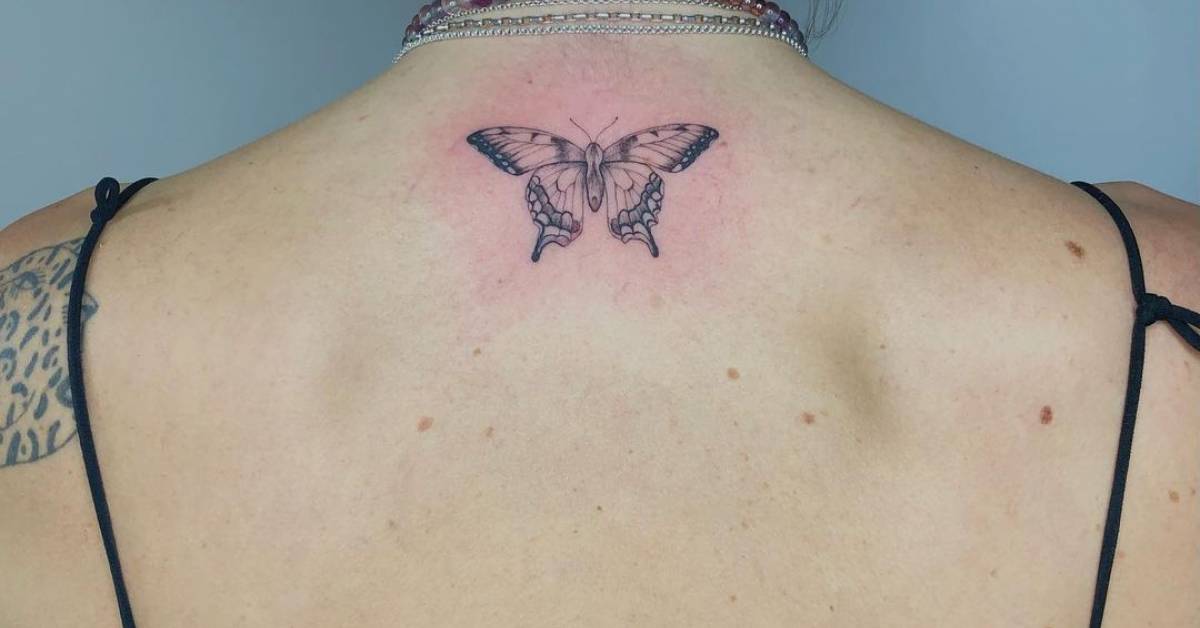 Cute monarch butterfly tattooed on the upper back.