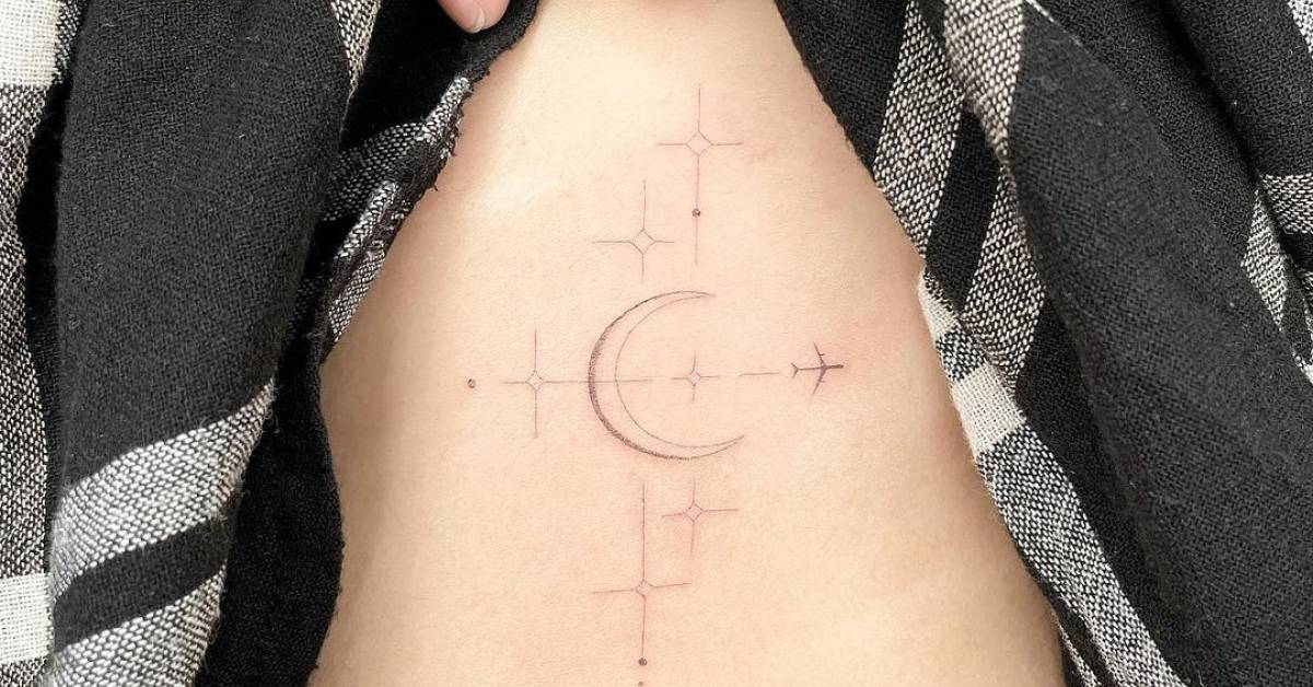 Fine line moon, stars and plane tattoo on the rib.