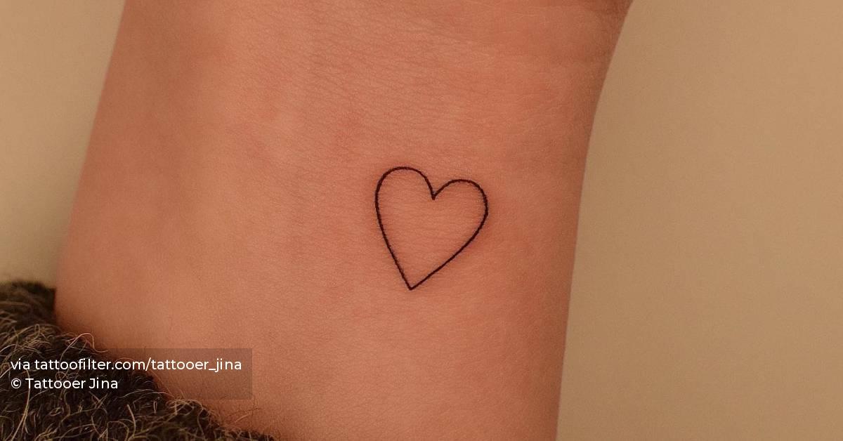 Heart tattoo placed on the wrist, minimalistic style.