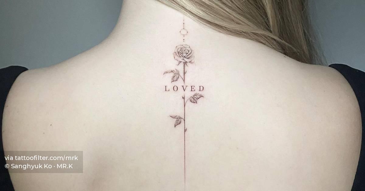 Single needle rose and the word "loved" tattooed on the