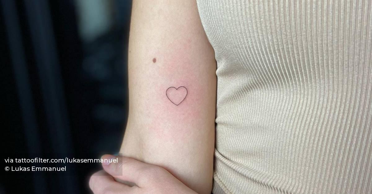Tiny minimalistic heart tattoo done on the inner arm.