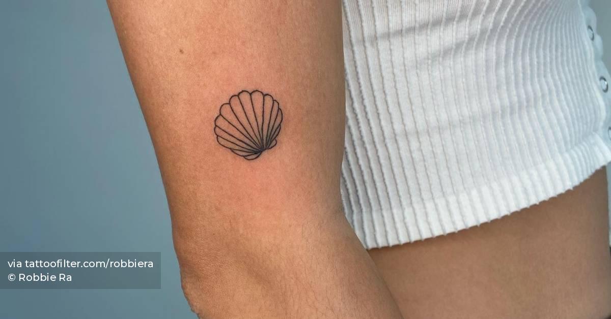 Shell tattoo placed on the upper arm.