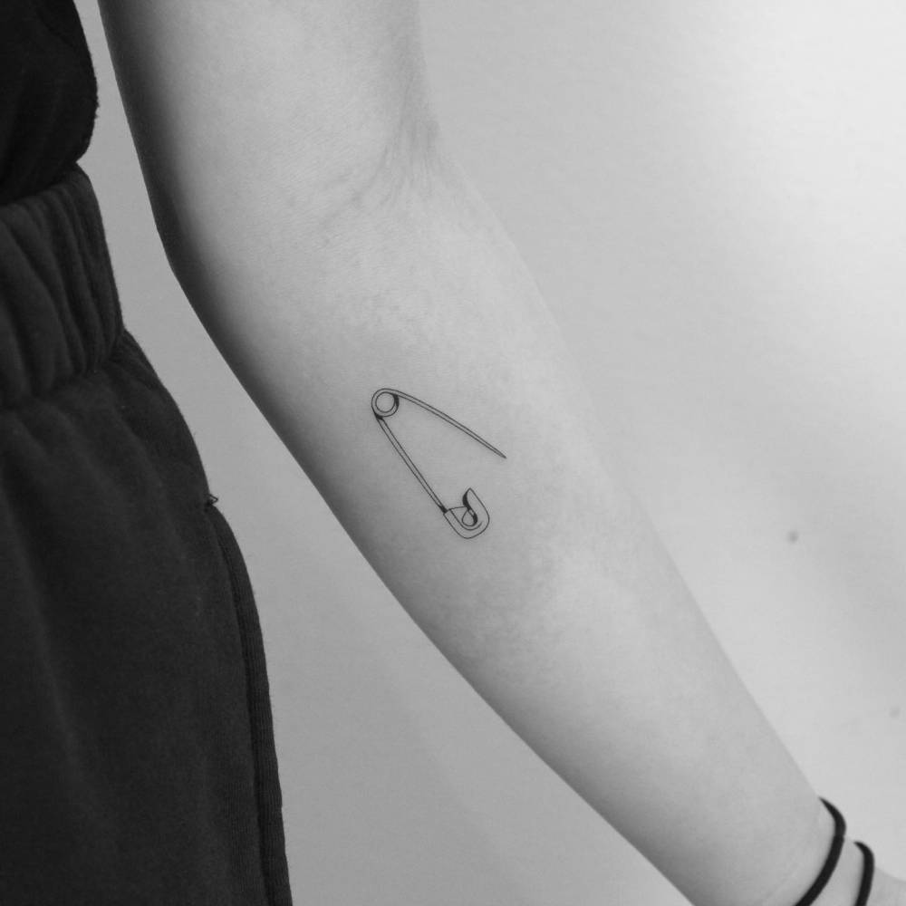 Fine Line Safety Pin Tattoo Located On The Inner