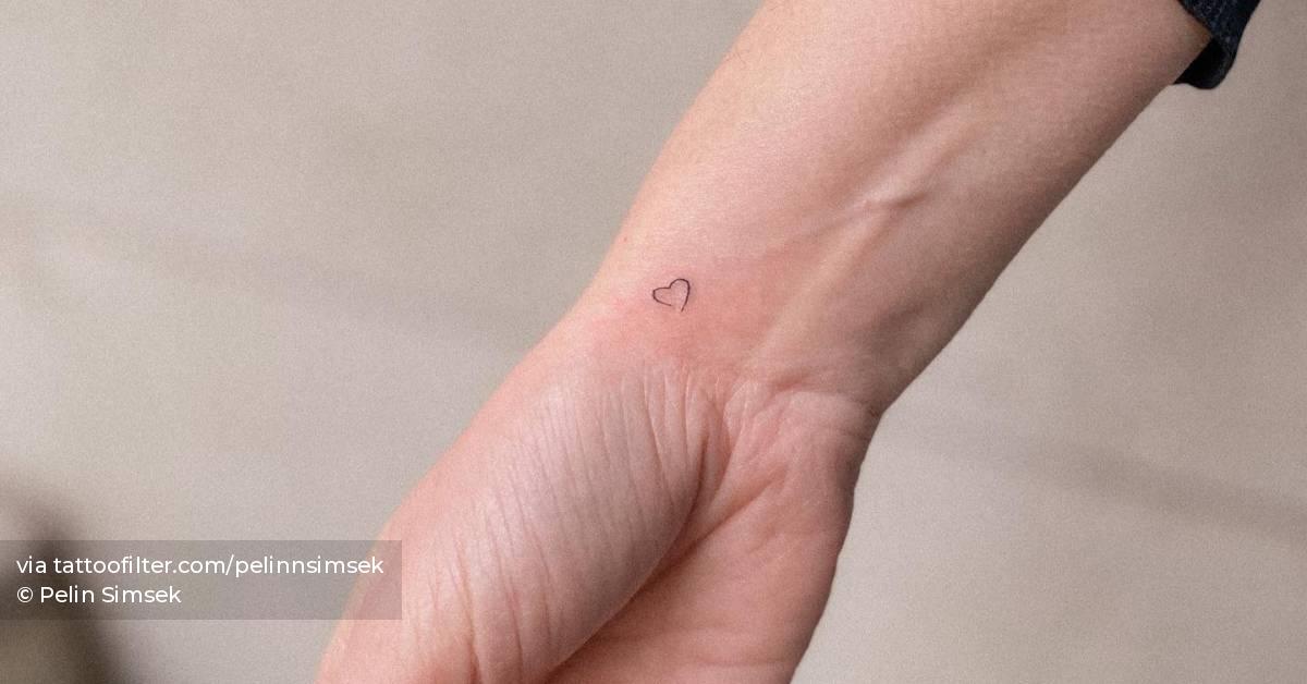 Tiny minimalistic heart tattoo done on the wrist.