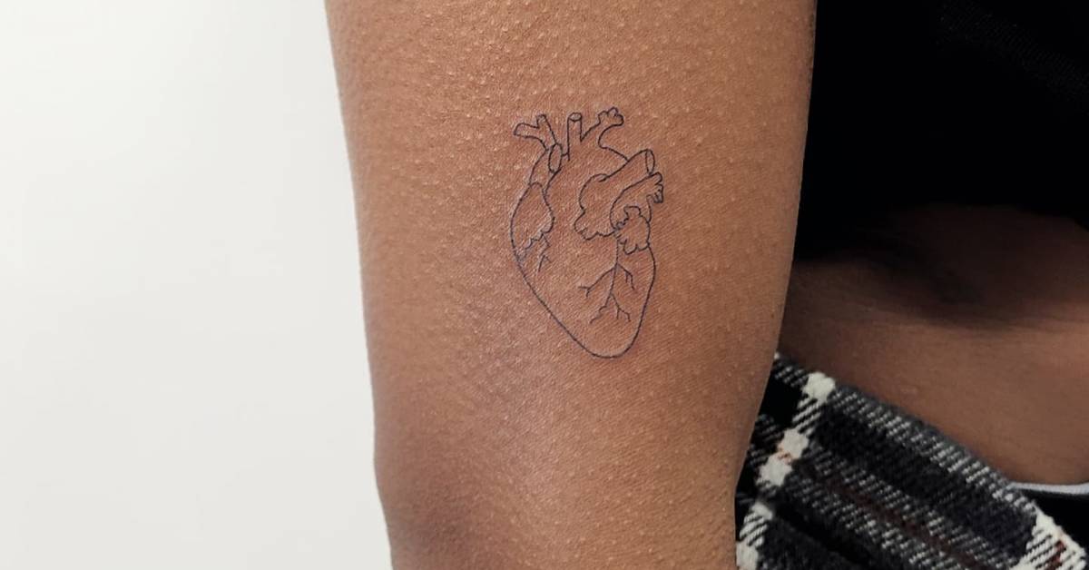 Fine line anatomical heart tattoo located on the upper
