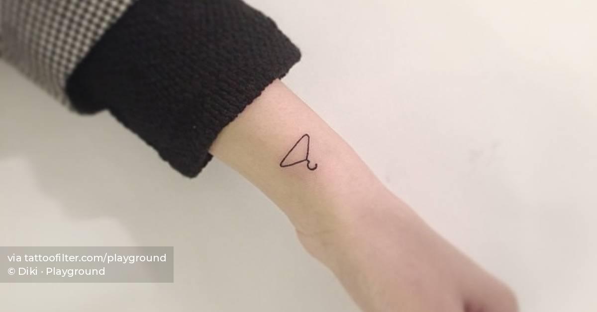 Minimalistic style clothes hanger tattoo on the wrist.