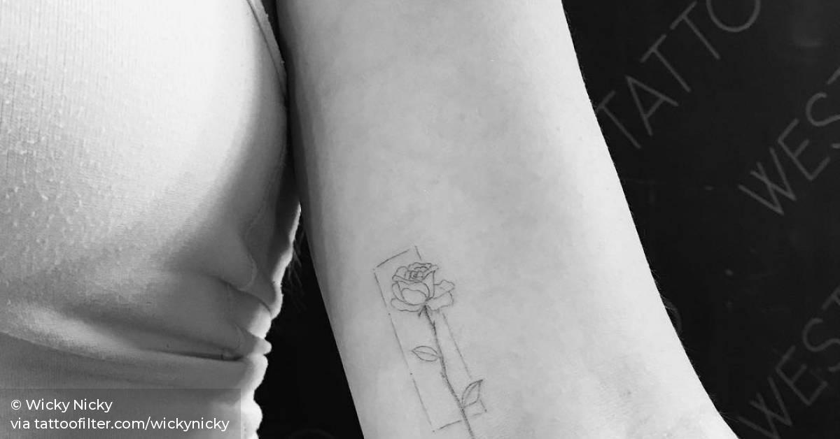 Single needle rose tattoo on the left inner arm.