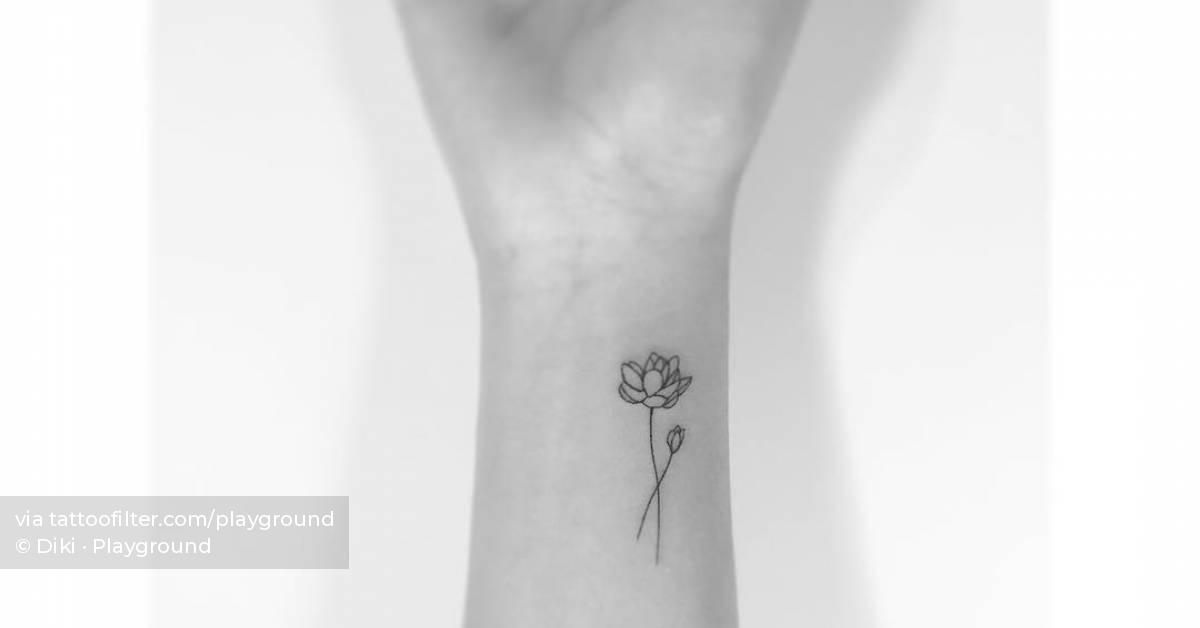 FIne line lotus flower tattoo done on the wrist.