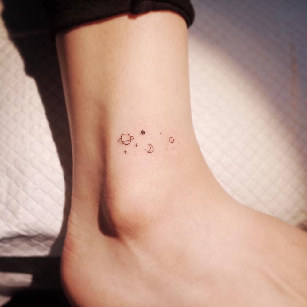 Minimalist galaxy tattoo on the ankle.