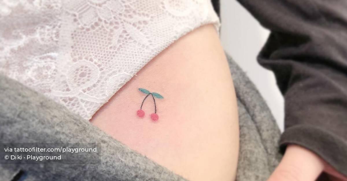 Cherry tattoo located on the pelvis.