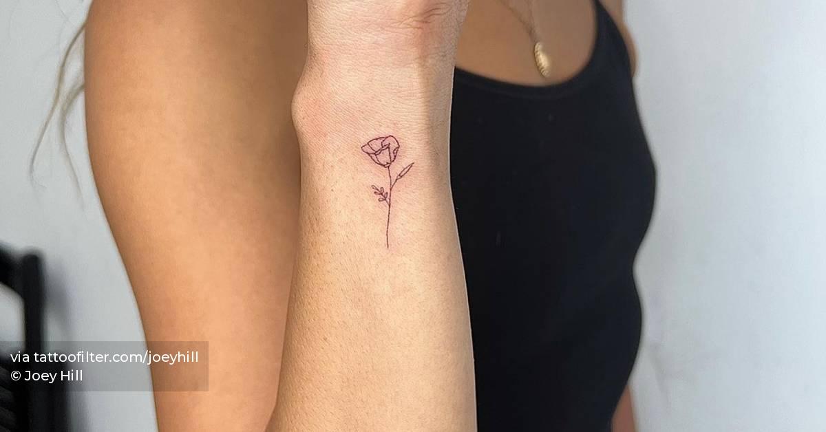 Fine line flower tattoo done on the wrist.