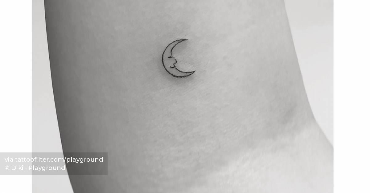 Minimalistic moon face tattoo located on the inner