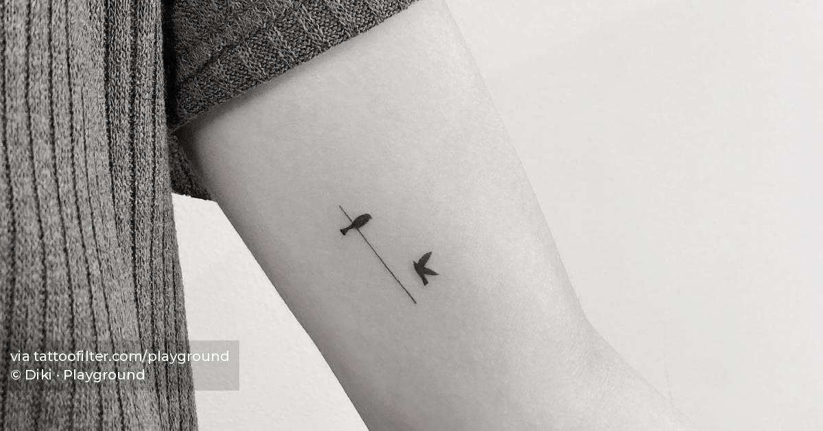 Minimalistic birds on a wire tattoo on the inner arm.