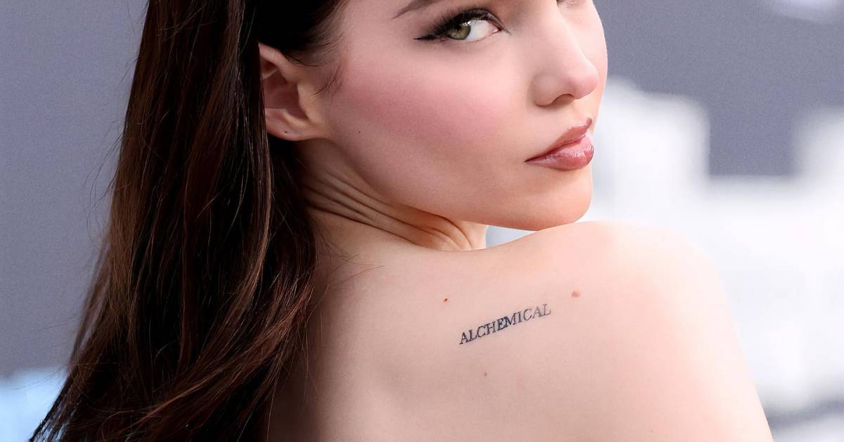 Tattoo that says "alchemical" located on Dove Cameron's