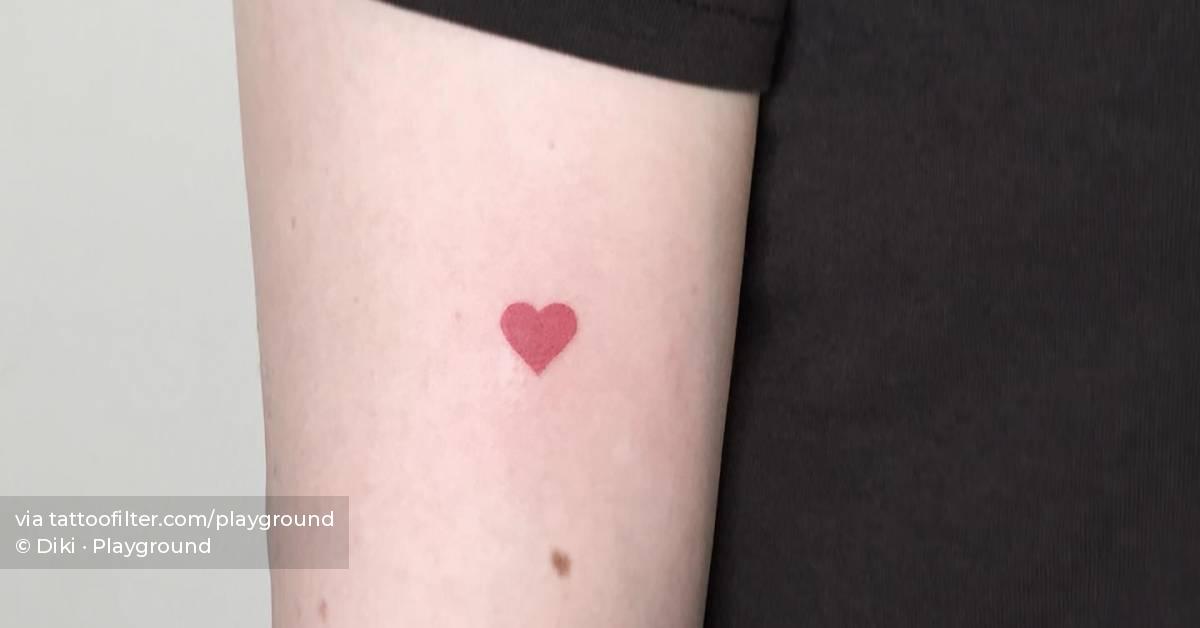Minimalistic red heart tattoo located on the tricep.