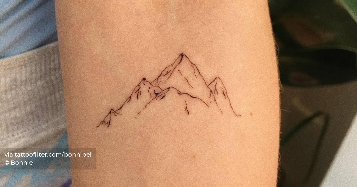 Fine line mountain tattoo done on the inner forearm.