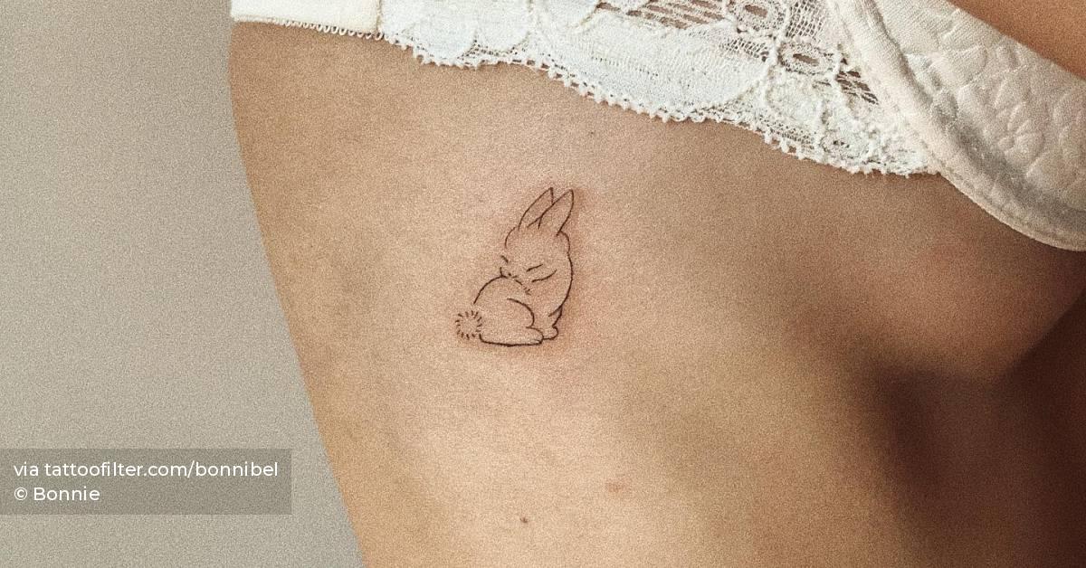 Fine line bunny tattoo located on the side boob.