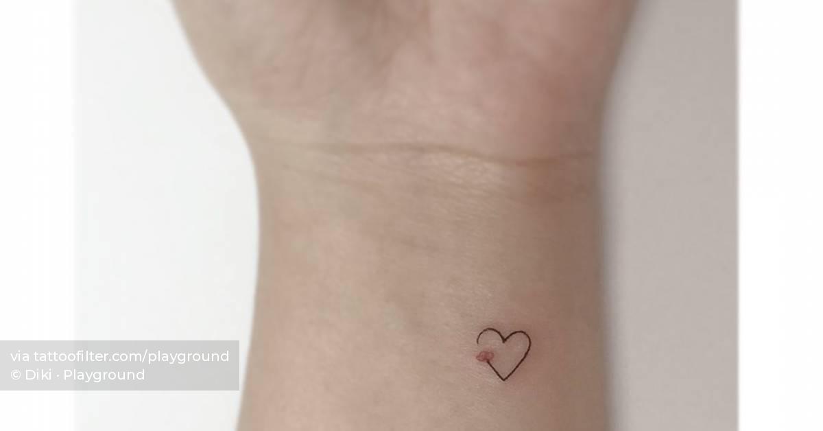 Tiny heart and flower tattoo located on the wrist,