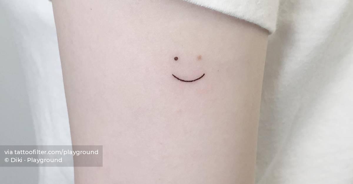 Minimalistic smiley tattoo used as birthmark coverup.