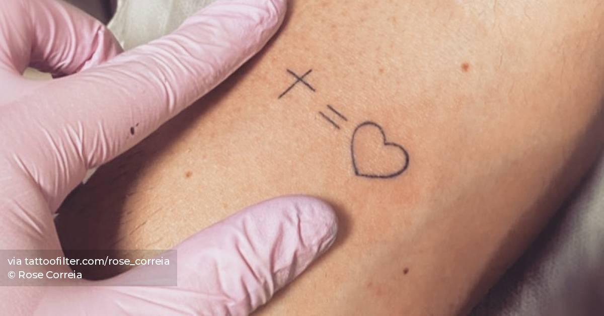 Minimalistic cross equals heart tattoo located on the