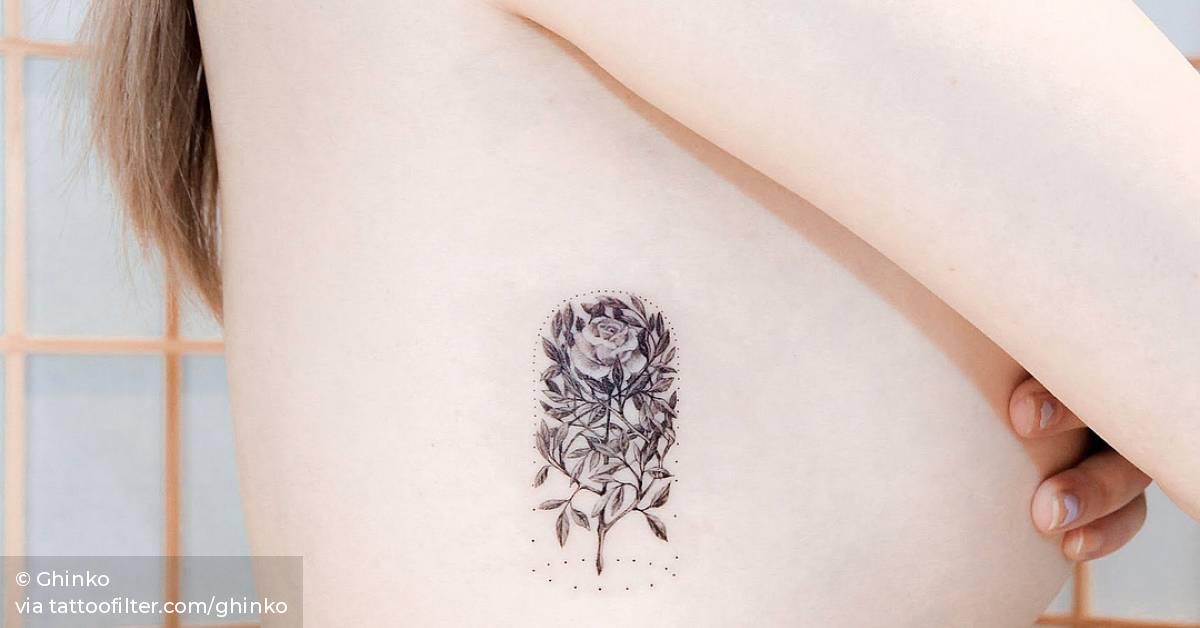 Rose in a glass dome tattoo on the right ribcage.