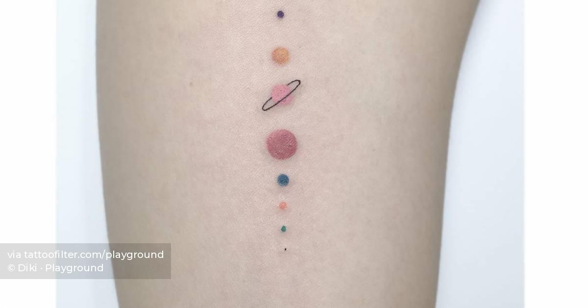Solar system tattoo located on the inner arm,