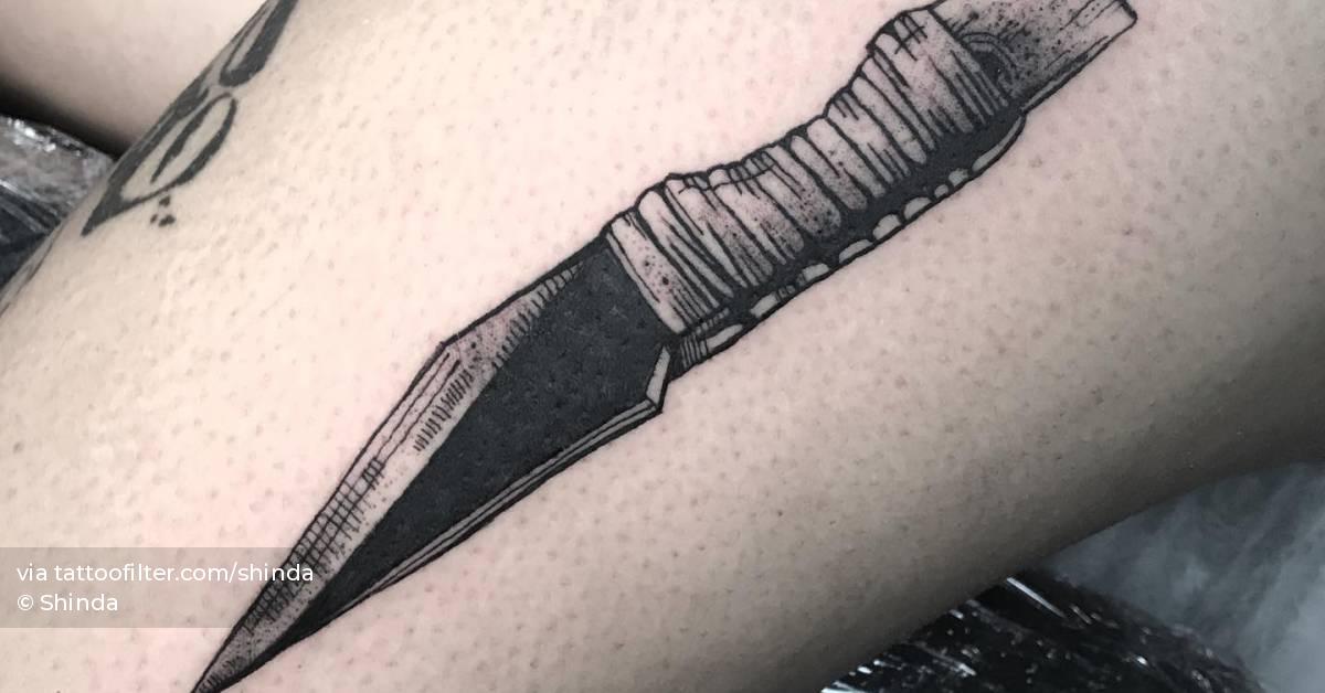 Blackwork style knife tattoo located on the thigh.
