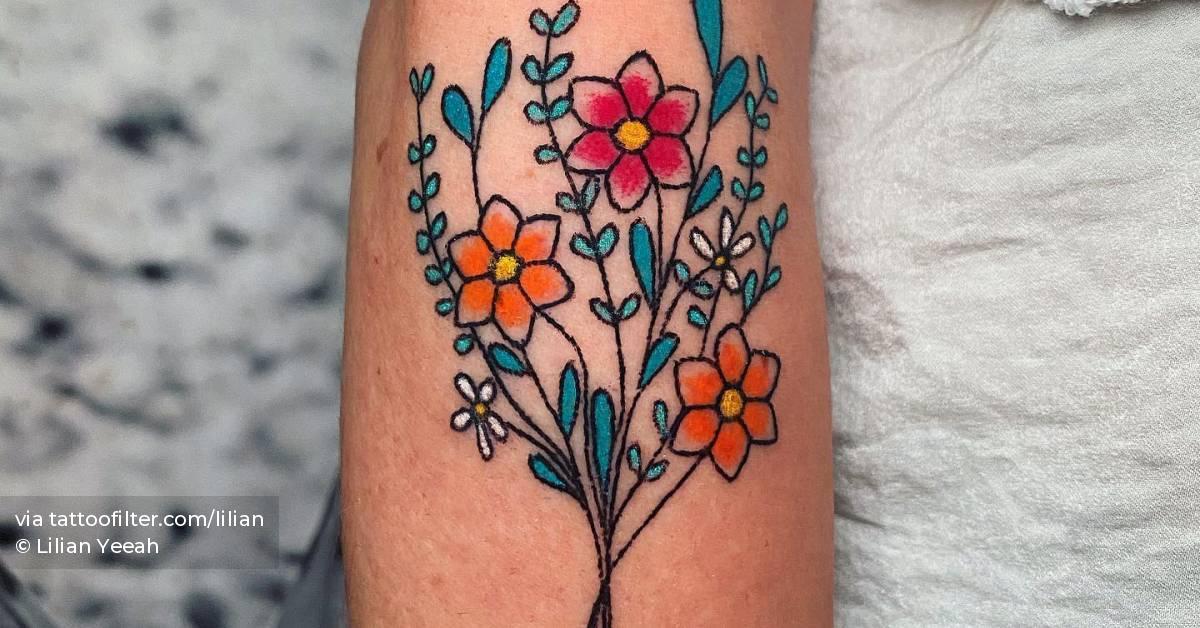 Hand poked flower bouquet tattoo located on the