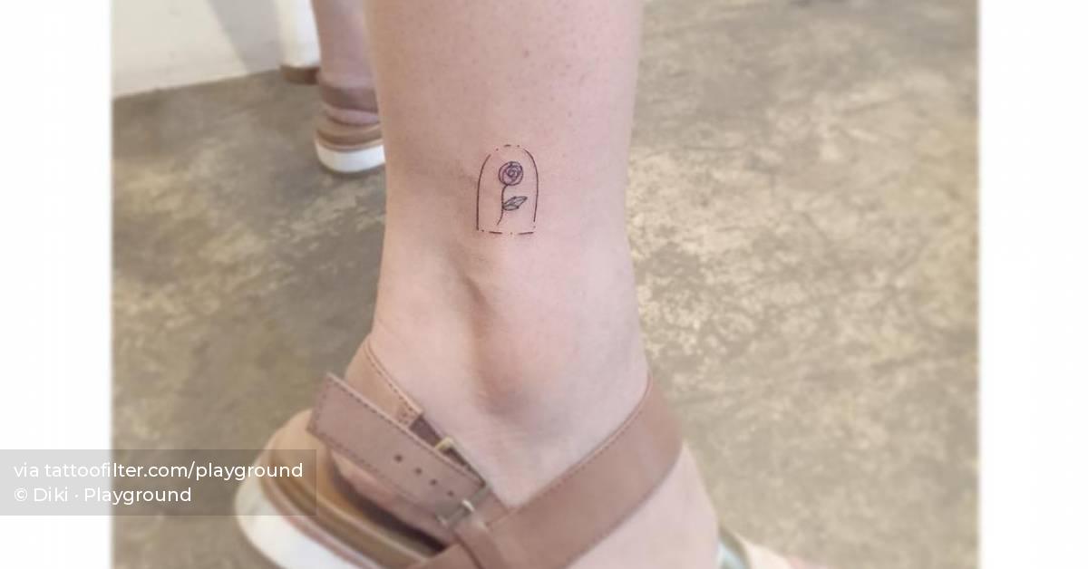 Minimalistic style rose in a glass dome tattoo located