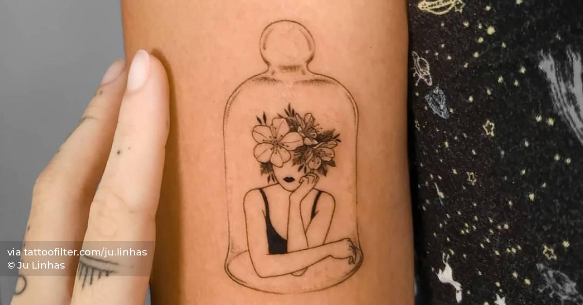 Flower head woman in a glass dome tattooed on the