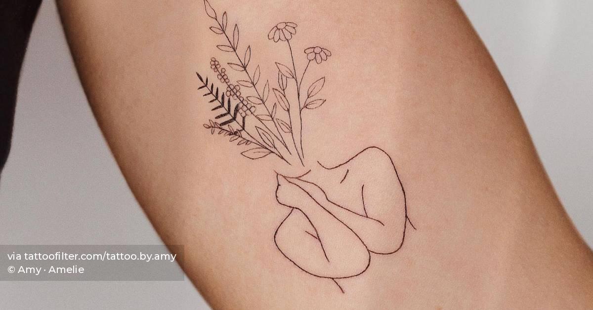 Fine line flower head woman tattoo located on the inner