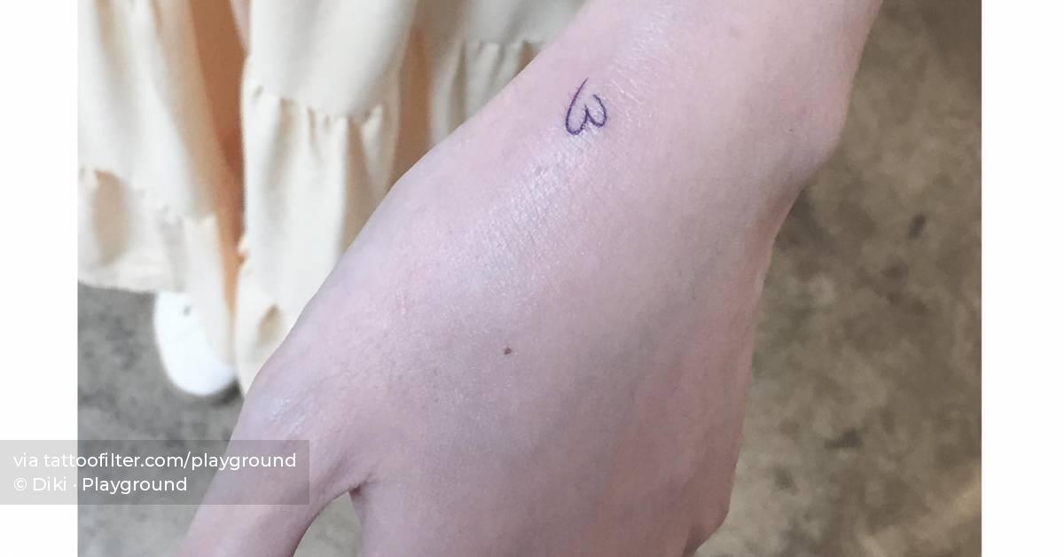 Tiny blue heart tattoo located on the wrist.