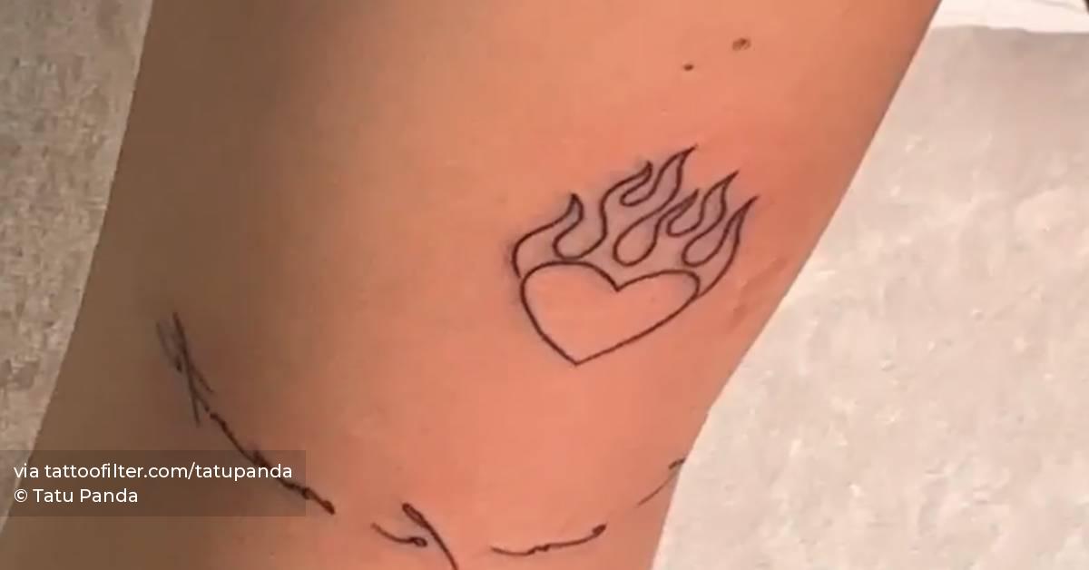 Flaming heart tattoo located on Emilia Mernes' upper