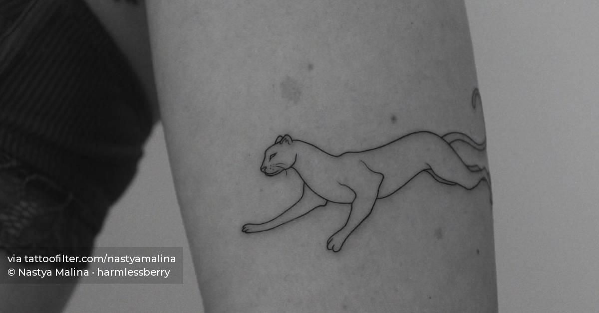 Fine line panther tattoo located on the upper arm.