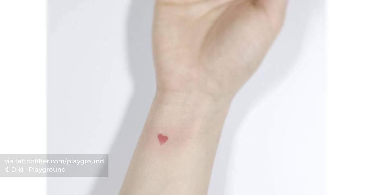Tiny red heart tattoo located on the wrist,