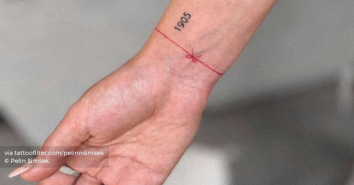 Minimalistic red wristband tattoo.