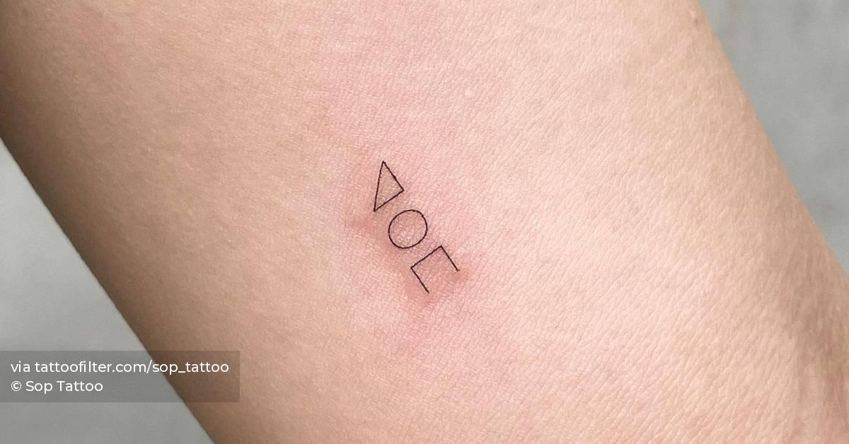 Minimalistic shapes tattooed on the inner arm.